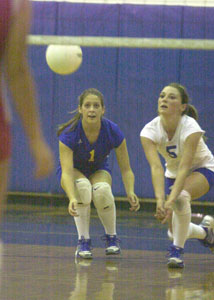 St. Marys' Ashley Hedrick, 1, and Liz Barton, 5, get in position for a dig against Lima Central Catholic on Tuesday night. St. Marys won the first game, but lost the last three to LCC.<br></br>dailystandard.com