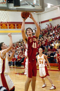 St. Henry's Kurt Huelsman, 41, scores two points in front of New Bremen's Scott Schnelle, left, during their game this past season. Huelsman, a University of Dayton signee, was named The Daily Standard's Boys Basketball Player of the Year.<br></br>dailystandard.com
