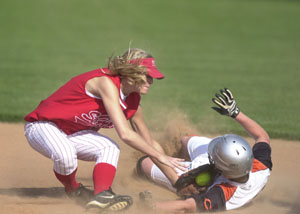 Coldwater's Amber Heyne, right, slides under the tag of St. Henry's Bethany Puthoff, left, during their Midwest Athletic Conference contest on Thursday at the Wally Post Athletic Complex. Coldwater defeated St. Henry, 7-1.<br></br>dailystandard.com