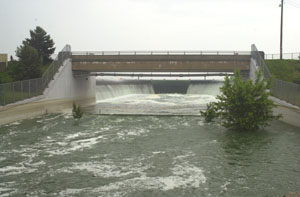 Water rushing over the Grand Lake spillway this morning quickly fills the Beaver Creek below. The creek runs west toward the Wabash River, often flooding farmland near its banks. <br></br>dailystandard.com