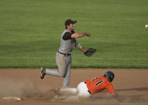 Minster's Aaron Heitbrink, 11, tries to break up a double play as Parkway's Derik Snyder, top, throws to first base during their ACME contest on Tuesday night. Snyder completed the double play and Parkway went on to defeat Minster, 7-2.<br></br>dailystandard.com