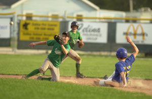 Celina's Dustin Abrahamson, left front, goes to his knees to catch the ball as Marion Local's Greg Koesters, right, slides safely into second base while Celina's John Bonvillian, back, looks on from behind during an ACME game on Monday night at Eastview Park. <br></br>dailystandard.com