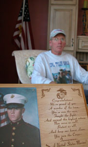 Coldwater resident Nick Kahlig is shown with a photo of his son, Tyler, a U.S. Marine who will return for another tour in Iraq next spring. Kahlig and friend, Nick Ruchty, are running in the Marine Corps Marathon in Washington, D.C., on Sunday in honor of Tyler and other military men and women.  <br></br>dailystandard.com