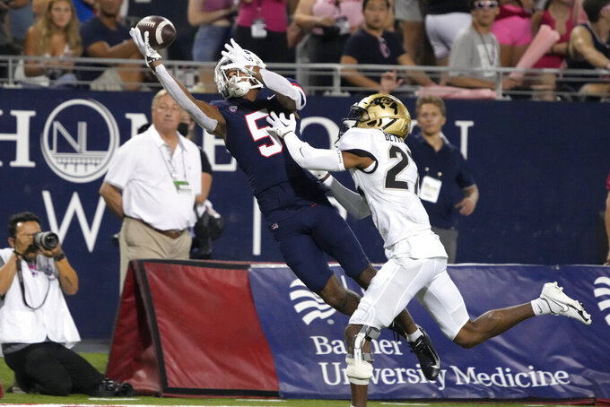 Arizona wide receiver Dorian Singer (5) makes the catch while being defended by Colorado cornerback Nigel Bethel Jr. in the first half during an NCAA college football game, Saturday, Oct. 1, 2022, in Tucson, Ariz. (AP Photo/Rick Scuteri)