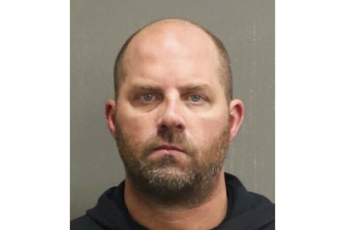 This booking photo released by the Metropolitan Nashville Police Department shows Harry Jerome Barker, also known as Jay Barker, on Saturday, Jan. 15, 2022. Tennessee authorities say the former Alabama quarterback was arrested on a felony domestic violence charge. The 49-year-old is married to country music singer Sara Evans and was booked into a Nashville jail early Saturday morning. (Metropolitan Nashville Police Department via AP)