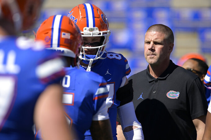 FILE - Florida head coach Billy Napier, right, watches players warm up before an NCAA college football game against Eastern Washington, Sunday, Oct. 2, 2022, in Gainesville, Fla. A person familiar with the situation says Florida quarterback recruit Jaden Rashada requested a release from his national letter of intent Tuesday, Jan. 17, 2023 after a $13 million name, imagine and likeness deal fell through.(AP Photo/Phelan M. Ebenhack, File)