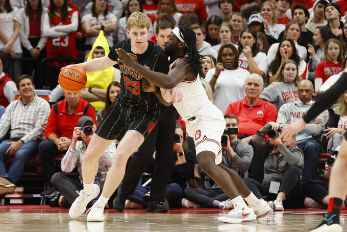Wisconsin's Steven Crowl, left, tries to dribble around Ohio State's Isaac Likekele during the second half of an NCAA college basketball game on Thursday, Feb. 2, 2023, in Columbus, Ohio. (AP Photo/Jay LaPrete)