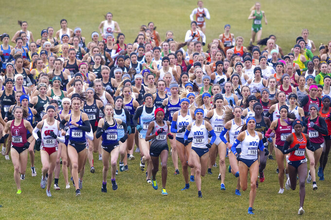 FILE - The field of runners compete in the women's NCAA Division I Cross-Country Championships, Saturday, Nov. 23, 2019, in Terre Haute, Ind. The pandemic shutdown created financial pressures, particularly for Division I programs with lost revenue from the cancellation of the NCAA men’s basketball tournament and uncertainty about whether football –- which largely funds schools’ abilities to offer Olympic and lower-profile sports programs –- would go forward at all. (AP Photo/Doug McSchooler, File)