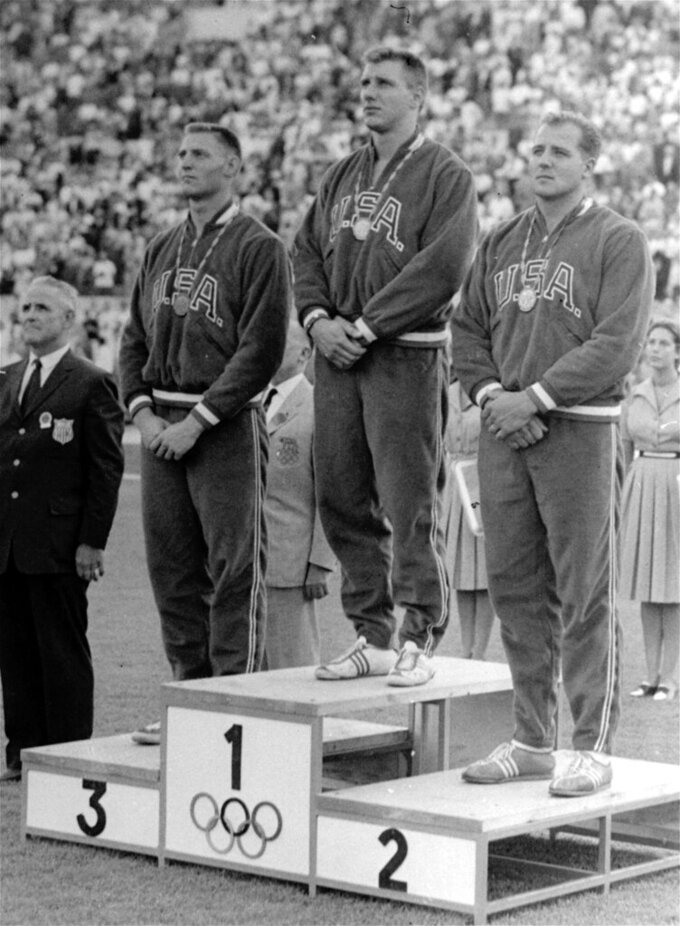 FILE - From left, American discus winners pose on the podium at the Olympic Games in Rome, Sept. 7, 1960. From left are bronze medalist Richard Cochran, gold medalist Alfred Oerter and silver medalist Richard Babka. Babka, a former world record holder who was part of a U.S. medals sweep in the discus at the 1960 Olympics,  died Saturday, Jan. 15, 2022. He was 85. (AP Photo/File)