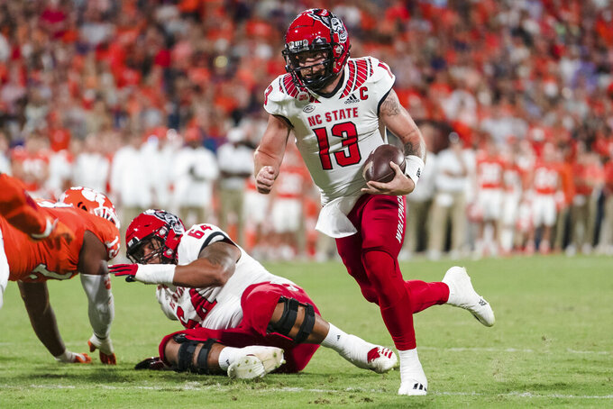 North Carolina State quarterback Devin Leary (13) runs with the ball in the first half of an NCAA college football game against Clemson, Saturday, Oct. 1, 2022, in Clemson, S.C. (AP Photo/Jacob Kupferman)