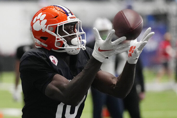 East wide receiver Joseph Ngata of Clemson catches a pass during football practice for the East West Shrine Bowl, Tuesday, Jan. 31, 2023, in Henderson, Nev. (AP Photo/John Locher)