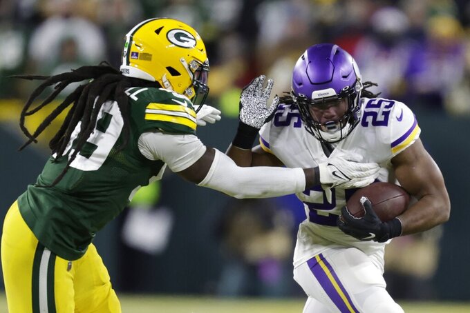 Minnesota Vikings' Alexander Mattison tries to get past Green Bay Packers' De'Vondre Campbell during the second half of an NFL football game Sunday, Jan. 2, 2022, in Green Bay, Wis. (AP Photo/Matt Ludtke)