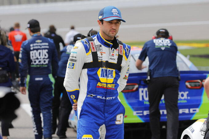 Chase Elliott stands on pit road as he waits to qualify for the NASCAR Cup Series auto race at Kansas Speedway in Kansas City, Kan., Saturday, Sept. 10, 2022. (AP Photo/Colin E. Braley)